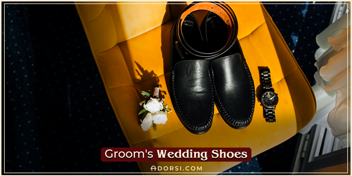 groom's weeding shoes and a belt beside a flower and watch to indicate getting ready for the big day 